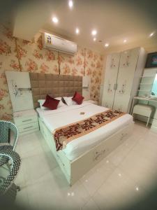 Fayfāʼفندق فيفاء的一间卧室配有一张大床和一把椅子