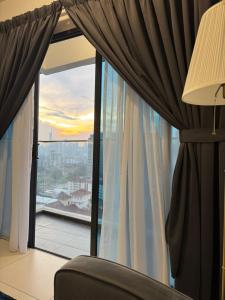 吉隆坡Reizz Residence by Perkasa的客房设有带沙发和灯的窗户。