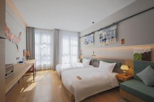 上海上海光时旅行酒店的酒店客房,设有两张床和一张沙发