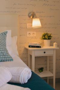 马拉加Larios Premium Apartments的一间卧室配有一张床和一张带台灯的桌子