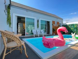 清刊Khiangkhoo Pool Villa ChiangKhan - เคียงคู่พูลวิลล่าเชียงคาน的游泳池里的粉红色充气火烈鸟