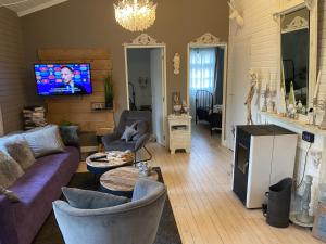 聚滕达尔Chalet Sint Barbara的客厅配有沙发、椅子和电视