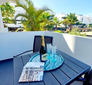 维拉韦德Casa Ana - Luxury pool apartment at Casilla de Costa的一瓶香槟和一张桌子上的两杯酒