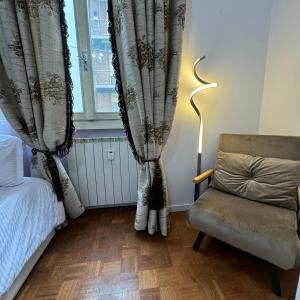 贝加莫Fenice的卧室配有床、椅子和窗户。