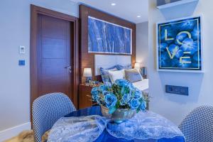 伊斯坦布尔Lord Morgan & Exclusive Design Cihangir的一间设有一张桌子的房间,花瓶是蓝色的