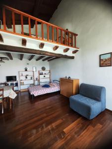 安圭拉萨巴齐亚Chalet Romantico Sul Lago的客厅设有蓝色的沙发和楼梯。