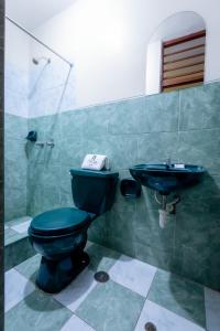 齐克拉约Hotel Italia II的浴室设有蓝色的卫生间和水槽。