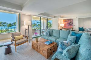科洛阿考艾岛凯悦Spa度假酒店的客厅配有蓝色的沙发和桌子