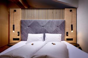 萨姆瑙恩Panorama Samnaun的卧室配有一张带两个枕头的大白色床