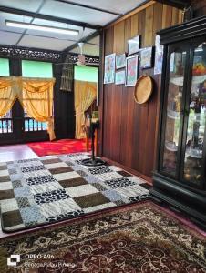 甲抛峇底Homestay Teratak Kayu kota Aur的客厅设有 ⁇ 格地板