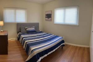 克利夫兰Quiet & Cozy home near Hospitals的一间卧室配有一张带蓝白条纹毯子的床