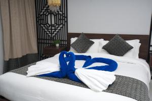 延布YM Resort的床上有蓝色的白色毛巾