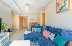 卡萨布兰卡Urban Charm Delight的客厅配有蓝色沙发及色彩缤纷的枕头