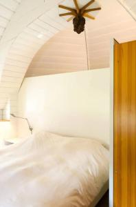 马尔森Historical house on river Vecht的卧室配有白色的床和吊扇