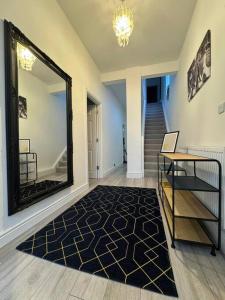 伦敦Modern 5 Bed near ExCel -Big Ben的走廊上设有镜子、桌子和楼梯