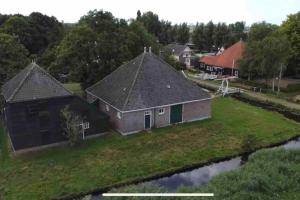 WatergangBeautiful farmhouse near Amsterdam center的河流上房屋的空中景观