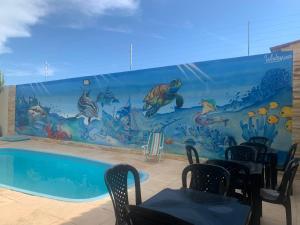 帕拉库鲁Happy Hostel e Pousada Paracuru的餐厅内游泳池的壁画