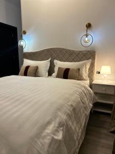 AfumaţiPensiunea Le Patrick的卧室配有一张带两个枕头的大白色床