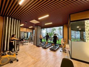 阿拉尼亚Serenity SPA ALL-IN apartment Luxury resort private beach的健身房,人们在房间内跑步机上锻炼