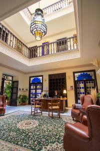 隆达Hotel Palacio de Hemingway的大型大堂设有桌椅和吊灯。