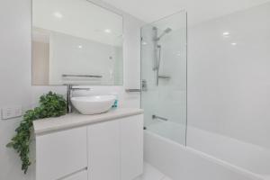巴迪纳卡瓦纳华特斯海滨度假酒店的白色的浴室设有水槽和淋浴。