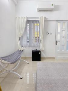 胡志明市SAIGONESE Studio的白色的客房设有吊床和门
