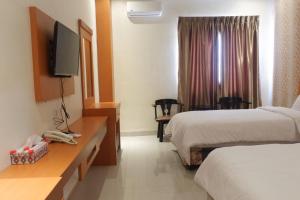 HaranggaulAgape Hotel Haranggaol的酒店客房设有两张床和一台平面电视。