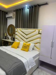 莱基Beautiful single room studio apartment in Ilasan lekki magnanimous的一间卧室配有一张带两个黄色枕头的床