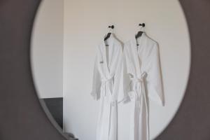 大田Workers Hotel Daejeon by Aank的镜子中两件白色衣服的反射