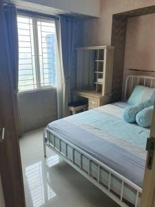 泗水Apartement orchard Surabaya的一间卧室设有一张大床和一个窗户。