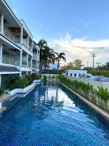 攀瓦海滩Bel Air Cape Panwa Resort Phuket的一座建筑物中央的游泳池