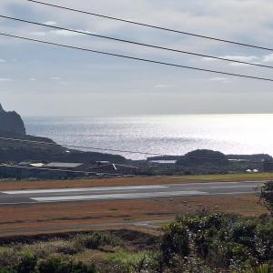 八丈町八丈島メープルハウス的一条空的路,在后面是大海