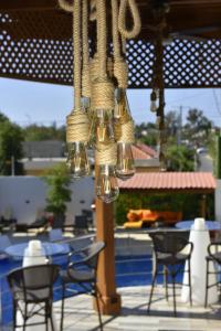 拉罗马纳Halibut Hotel的吊灯悬挂在带桌椅的庭院中