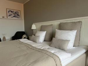 斯卡恩斯卡恩斯特兰德里酒店的一张配有白色床单和枕头的大床