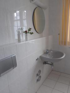 阿伦斯霍普Fewo Muschel incl Kurkarte Parkplatz und strandnah的白色的浴室设有水槽和镜子