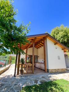 大特尔诺沃Villa Ksilifor的一个带木屋顶门廊的度假屋