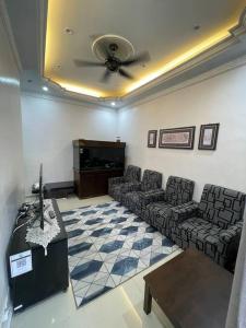 马六甲Homestay ShimahJay Telok Mas Melaka的带沙发、桌子和电视的等候室