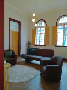 欧鲁普雷图É Hostel - Guesthouse的客厅配有沙发和两把椅子