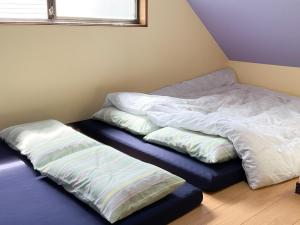 高松minpaku hotaru - Vacation STAY 65549v的两张睡床彼此相邻,位于一个房间里