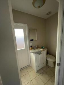 萨拉索塔Quaint Guest Room Close to Siesta Key的一间带卫生间、水槽和窗户的浴室