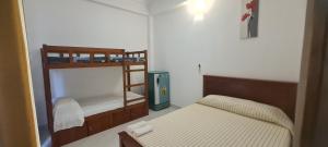 尼甘布Ceylon Lodge - Airport Transit Hotel & Hostel的一间小卧室,内设两张双层床