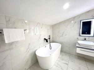 莱基Riviera Hotel, Apartments & Resorts的白色的浴室设有卫生间和水槽。