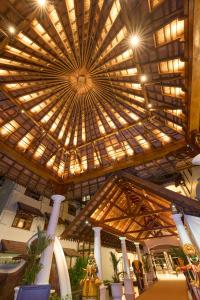 奎隆The Leela Ashtamudi, A Raviz Hotel的一座带灯光的大型木制天花板的建筑