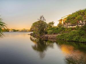 双水域赛贝尔双沃特酒店的一条河,河的两边有房屋和树木
