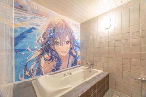 岐阜岐阜电影电影情趣酒店（仅限成人）的浴室的壁画旁边设有浴缸