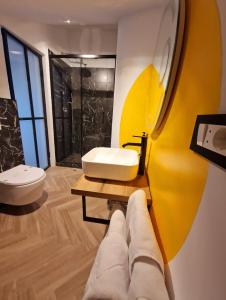 布拉索夫RA House的浴室设有白色水槽和黄色的墙壁