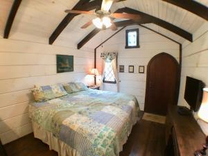 赛维尔维尔Tiny Home Cottage Near the Smokies #10 Helena的一间卧室配有一张床和吊扇