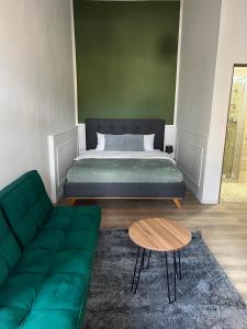 克卢日-纳波卡Homeland Center Cluj的一间卧室配有一张床、一张沙发和一张桌子