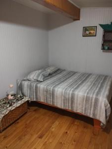 瓦尔迪维亚Casa de campo al lado de la ciudad 130 mts2的一间卧室配有一张床,铺有木地板