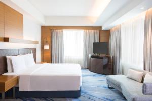 宿务Radisson Blu Cebu的酒店客房设有一张大床和一张沙发。